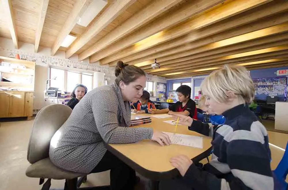 Anansi charter school teacher helping student