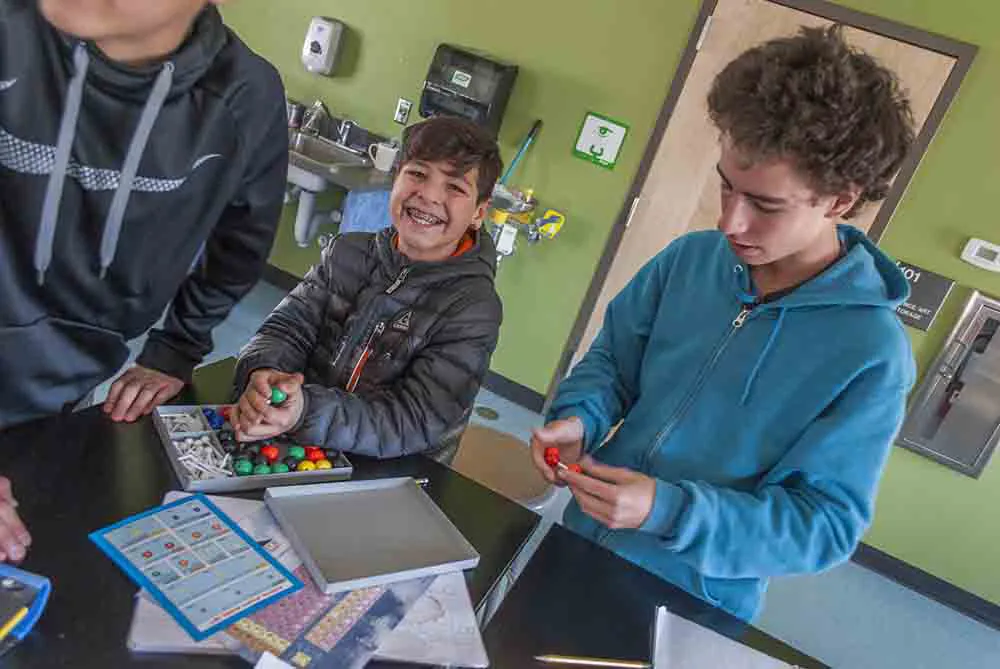 Anansi charter school kids using molecule kit