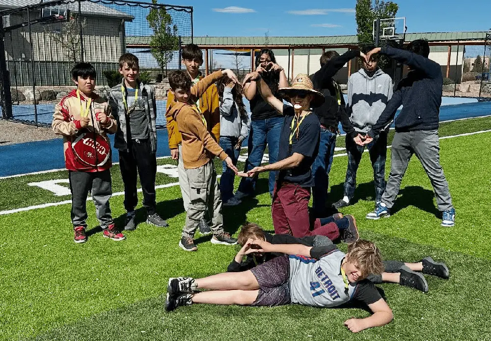 Taos Academy Youth posing on a football field