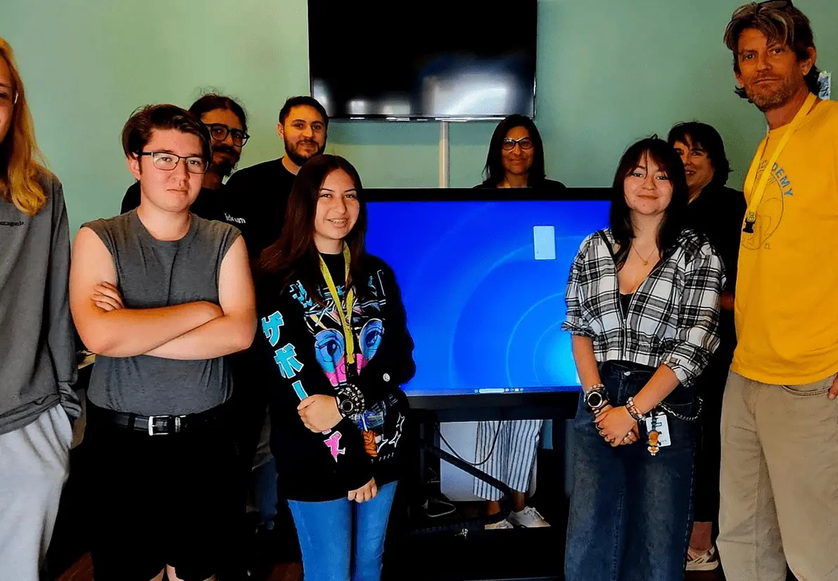 Taos Academy Youth posing in a classroom